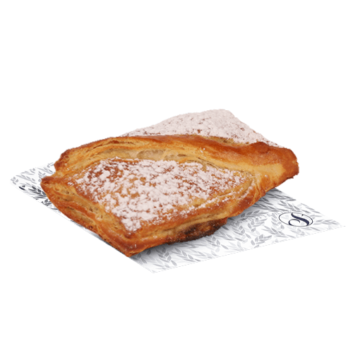 Flaky croissant, dusted with powdered sugar on a white plate