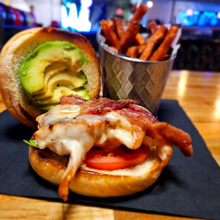 Chicken club sandwich served with a side of sweet potato fries
