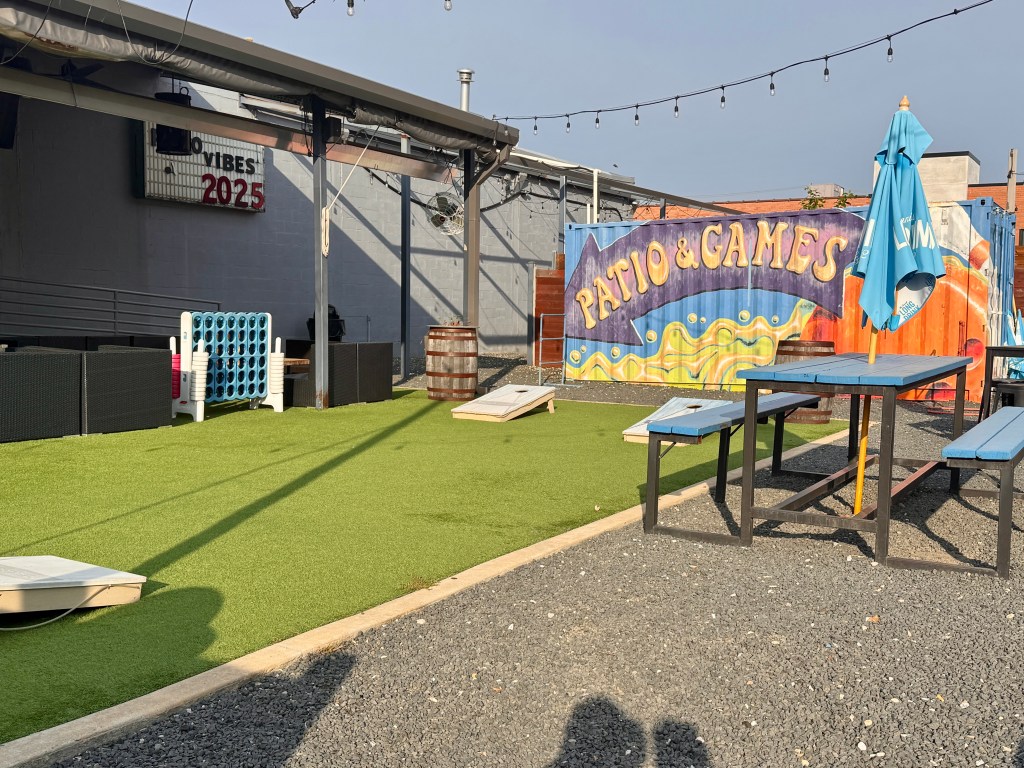 Patio seating on artificial turf, under covered awning